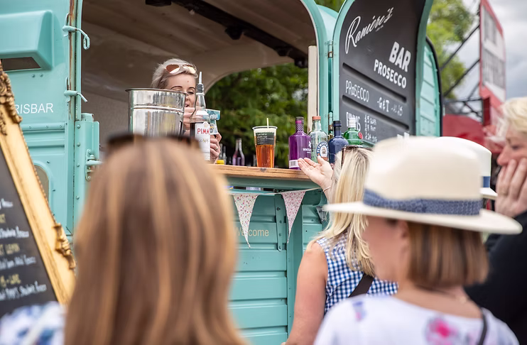 Crowds gather at a vintage drink truck